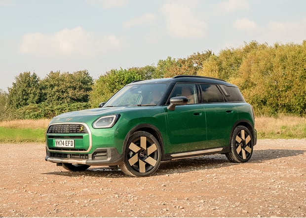 Front angled view of green MINI Countryman on city street