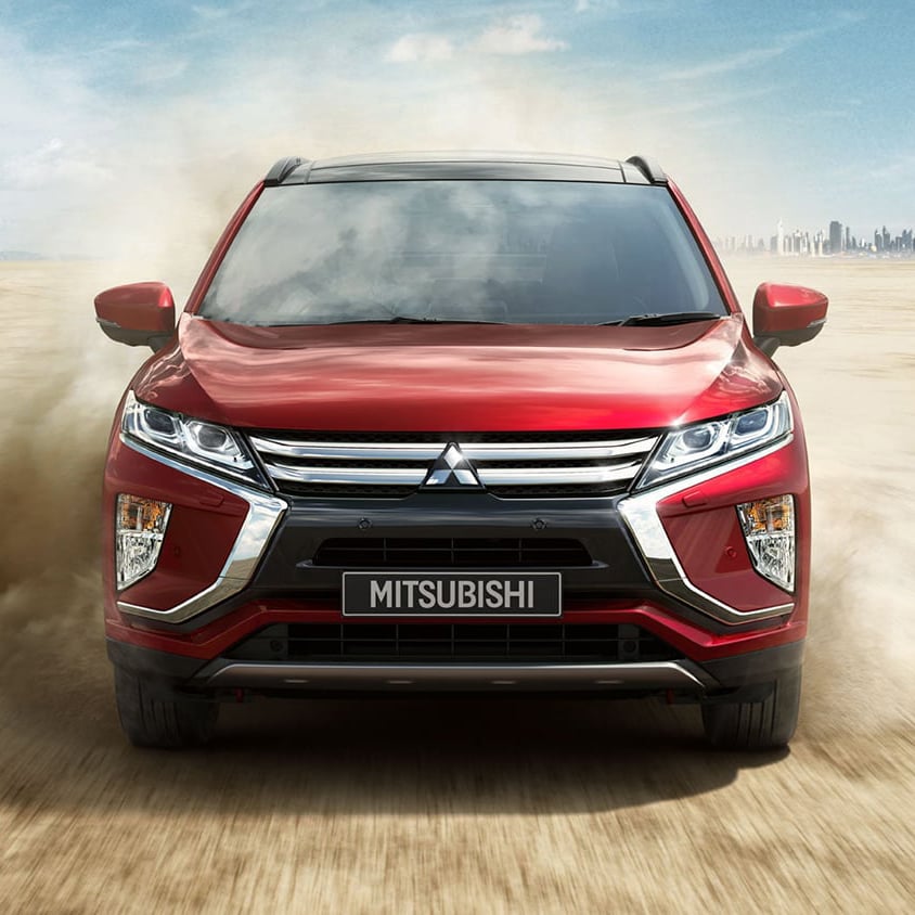 Front view of red Mitsubishi Eclipse Cross driving in the desert