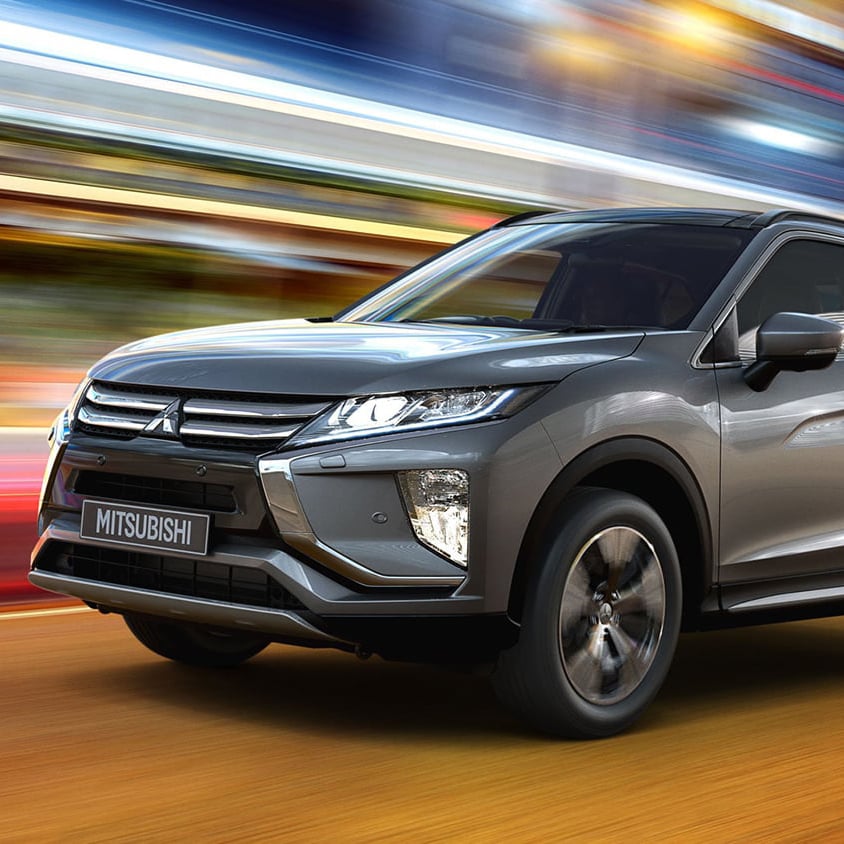 Grey Mitsubishi Eclipse Cross driving on a city road