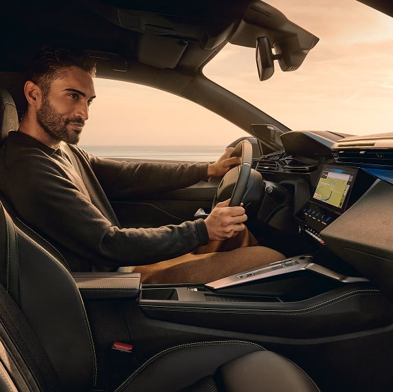 Interior view of Peugeot 408 with model looking at screen