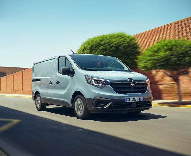 Renault Trafic driving along sunny city road