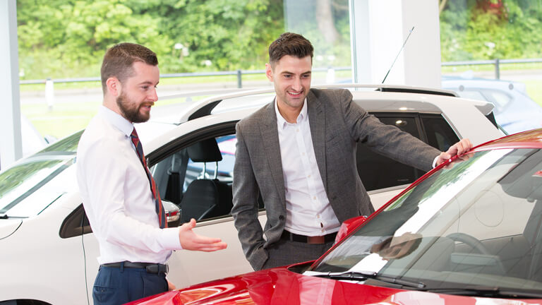 Employee helping man in showroom