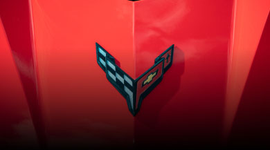 Close up of Corvette badge on a red bonnet
