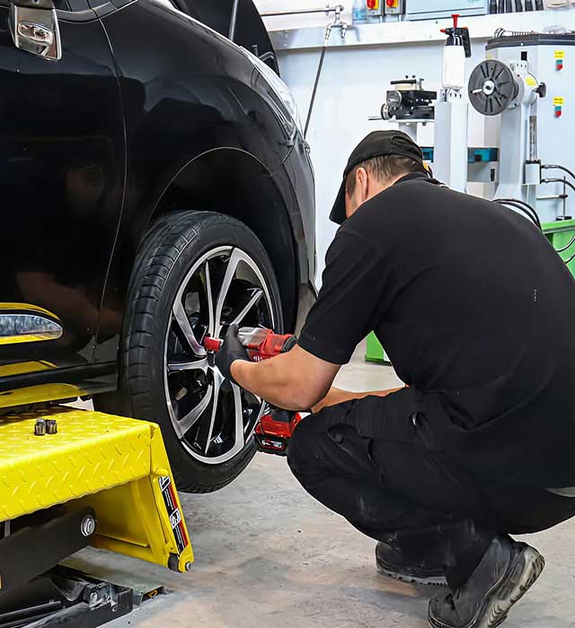 Expert inspecting tyre