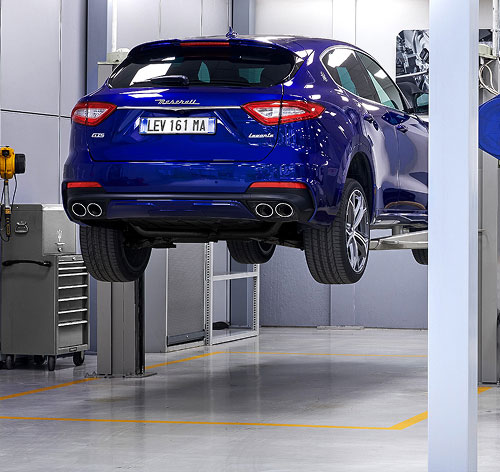 Blue Maserati Levante on garage ramp