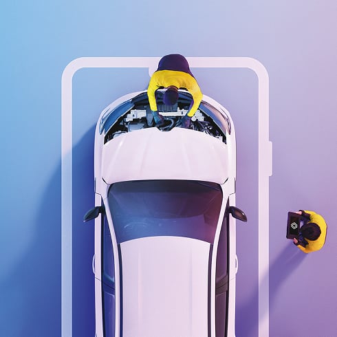 Top view of a mechanic inspecting a white car engine inside a marked parking spot, while another person holds a toolbox nearby