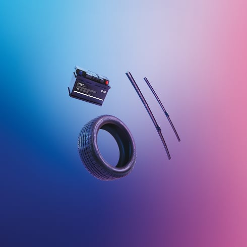 Car battery, tire, and two windshield wipers floating against a blue and pink gradient background