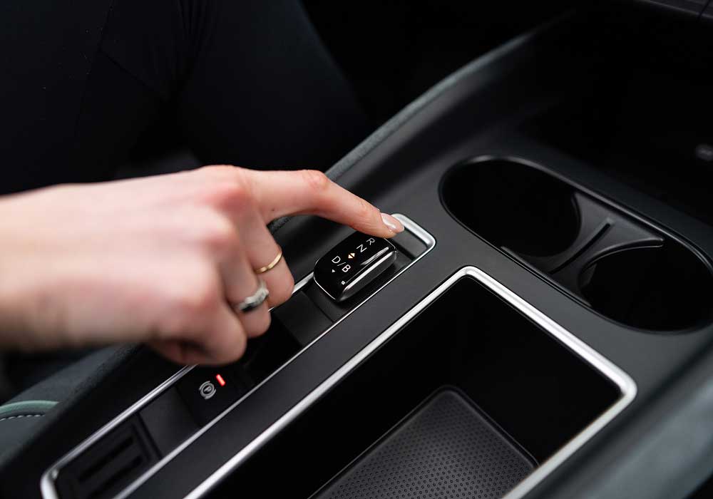 Close up of womans hand selecting transmission switch