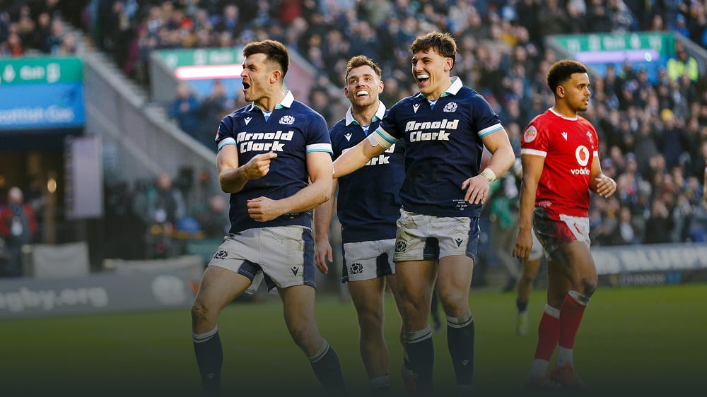 Scotland rugby players celebrating on the pitch.