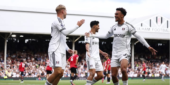 Fulham players celebrating during a football match.