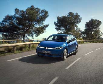 Volkswagen ID. Polo driving on coastal road in the sunshine