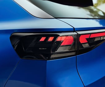 Close-up of the sleek rear LED tail light on a blue Volkswage T-Roc, showcasing sharp, angular design details